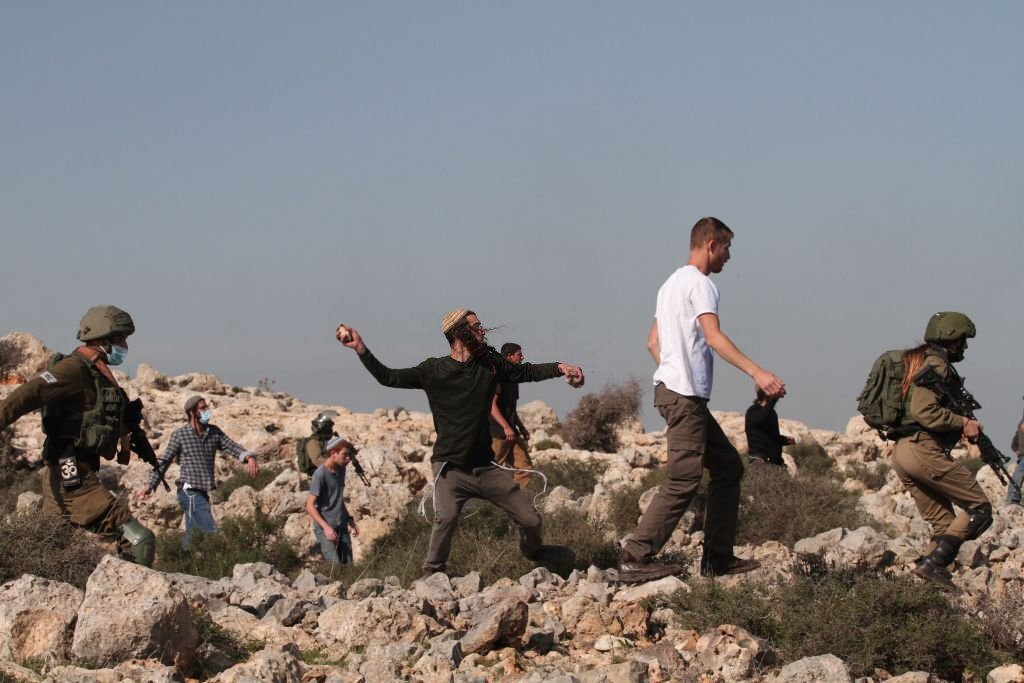 سلفيت، 30 تشرين الثاني 2020، مستوطنون يلقون الحجارة صوب متظاهرين فلسطينين احتجوا على توسع إحدى المستوطنات القريبة على حساب أراضيهم. (نضال اشتية/ وكالة شينخوا الصينية)